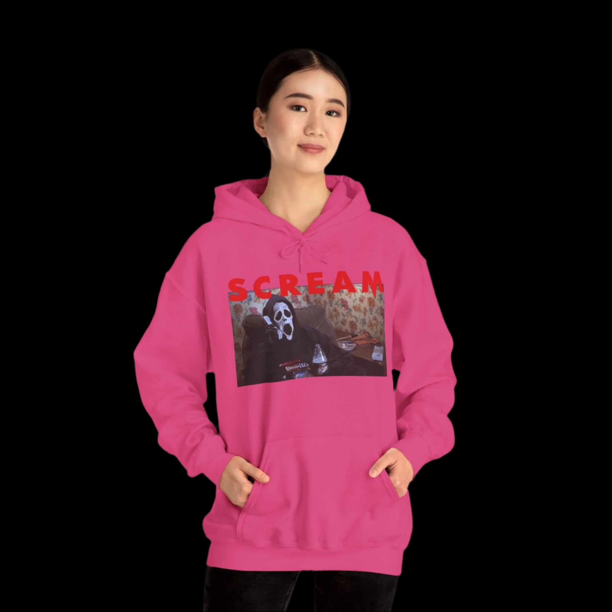 Person wearing a pink hoodie with a graphic design and the word 'SCREAM' on a white background