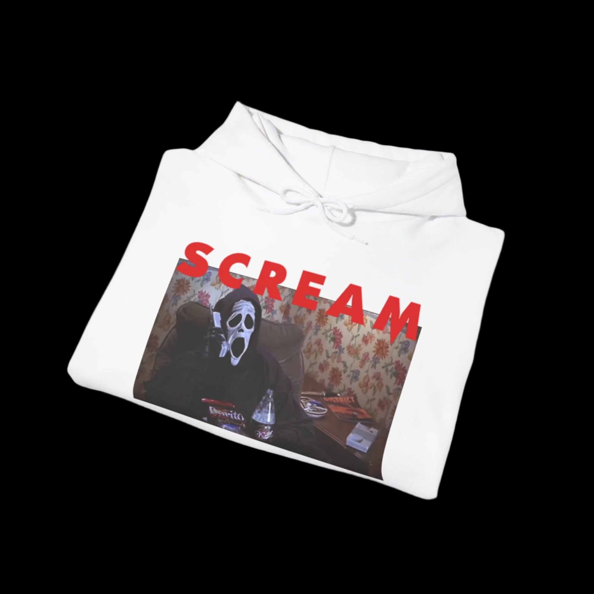 Folded white hoodie with 'SCREAM' text and graphic design on a white background