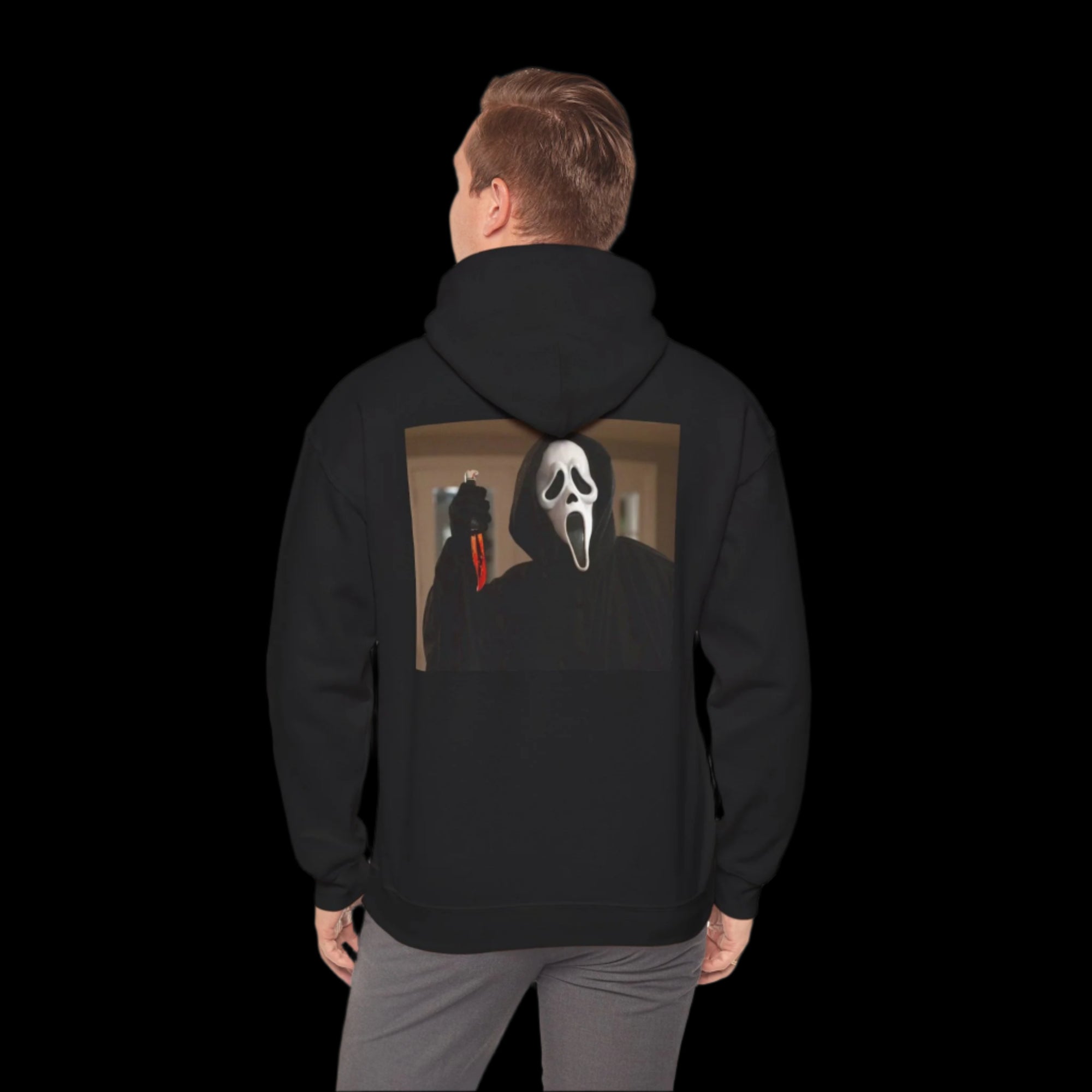 Person wearing a black hoodie with a Ghostface design on the back, standing against a white background.