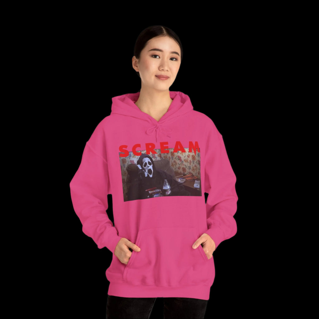 Person wearing a pink hoodie with a graphic design and the word 'SCREAM' on a white background